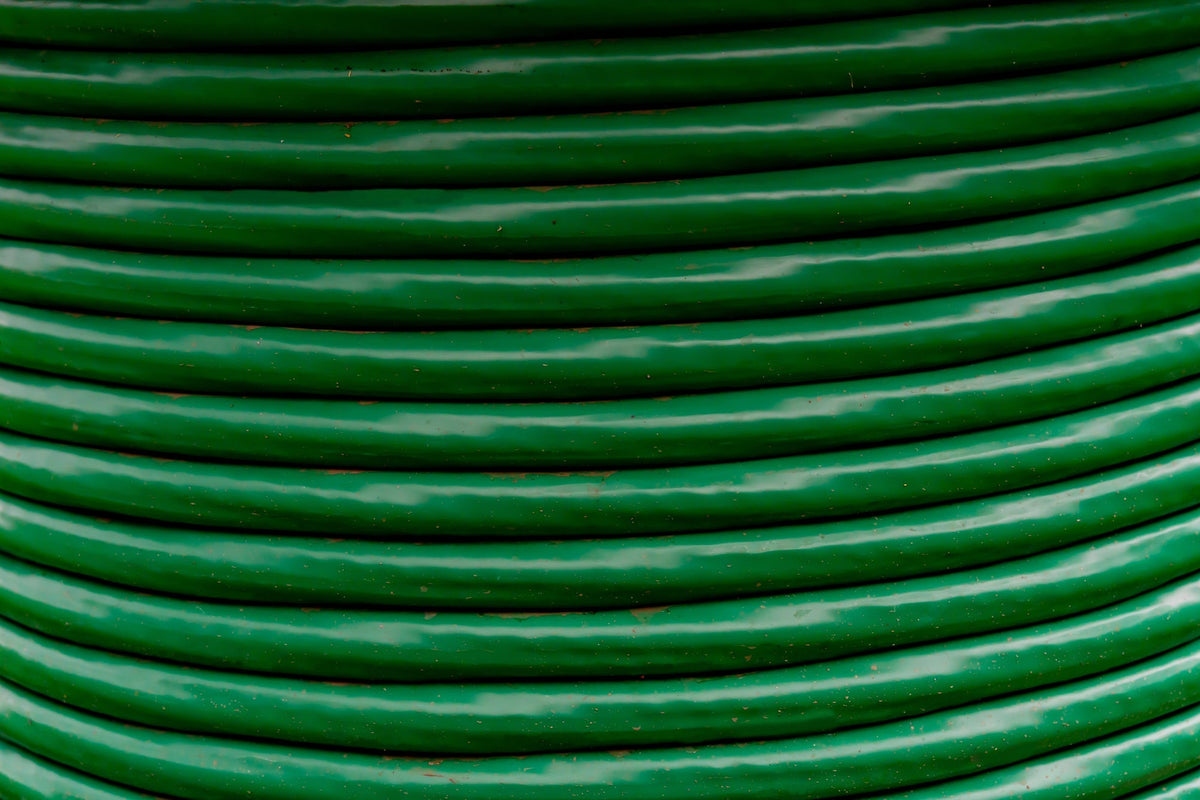 A closeup of a spool of green cable wire.